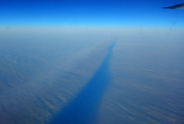 Airplane contrail's dark shadow