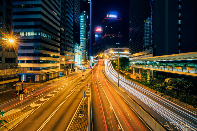 Traffic at central district in Hong Kong at sunset time. Car light trails and urban landscape in Hong Kong .