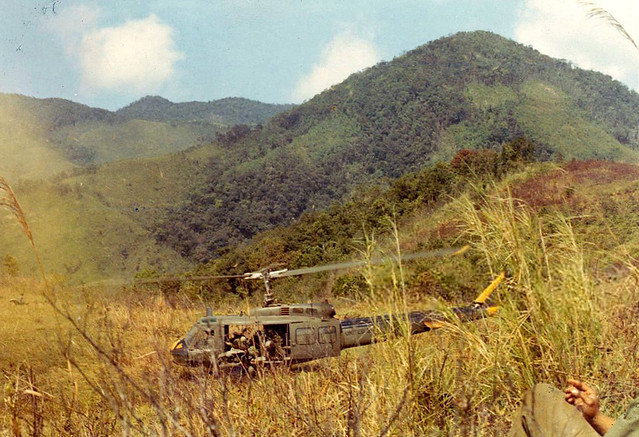 Vietnam War 1965 - Huey helicopter landing in a field in Vietnam during the Vietnam War