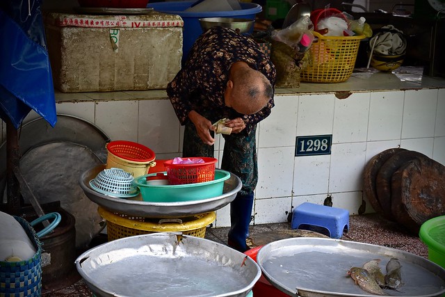 Fish Vendor:  Elderly Woman Counts Her Cash (Vietnamese Dong)