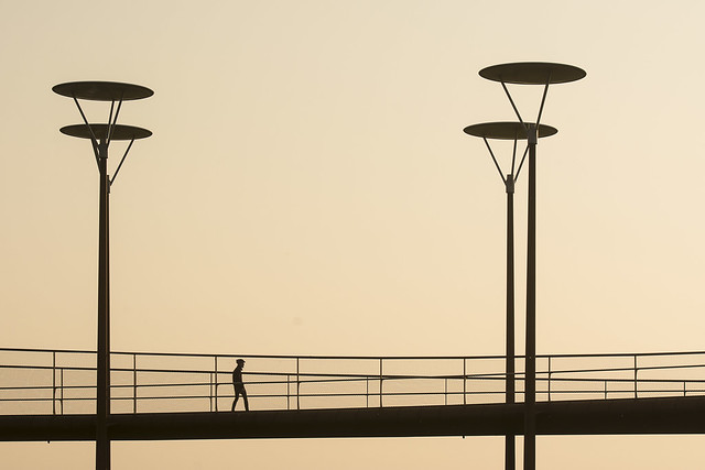 Four street lamps and a man