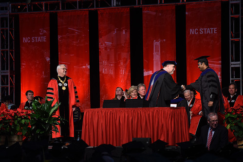 Chancellor Randy Woodson (left) awaits his turn to congratulate students as interim graduate school dean Peter Harries shakes hands with a new grad.