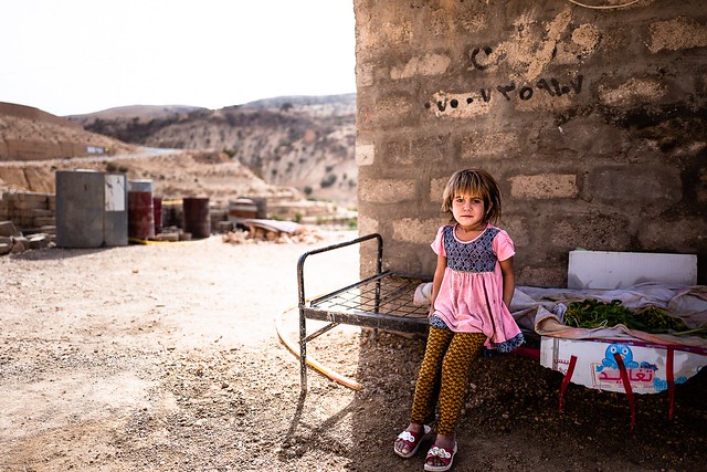 A little Yazidi girl on her bed in Mount Sinjar