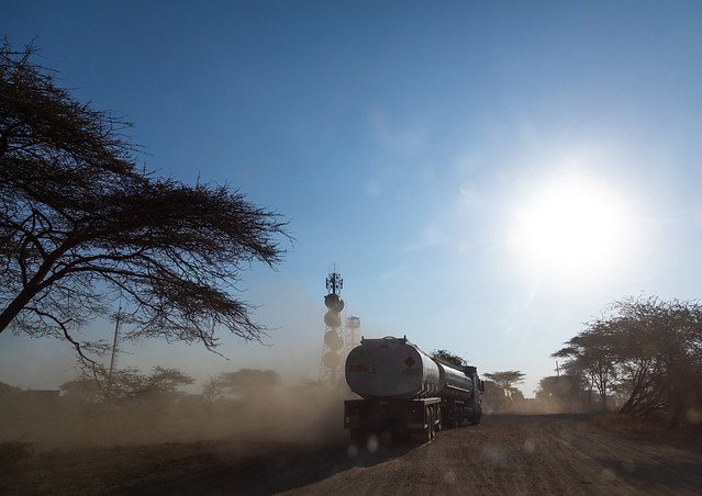 Trucks coming from djibouti port on a dusty road, Oromia, Awash, Ethiopia