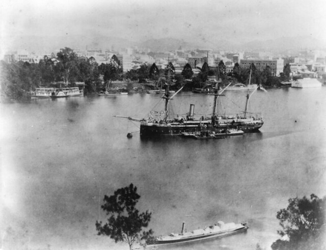 Royal Navy sloop Egeria with a coal barge alongside, and a Mosquito   small vessel in the foreground  in the Brisbane River 1889.