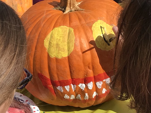 children painting on pumpkins