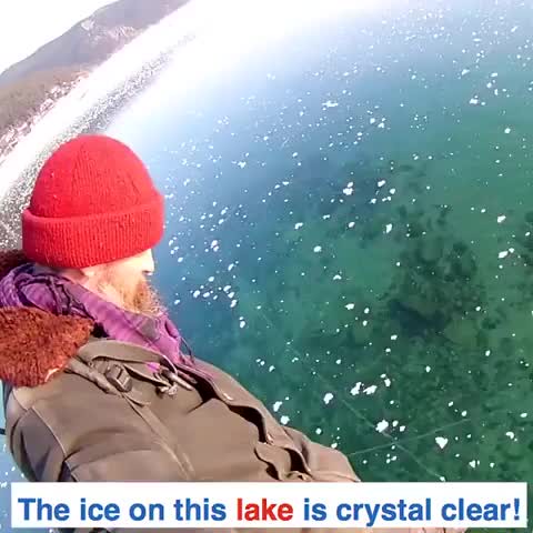 This man is walking on a crystal clear frozen lake