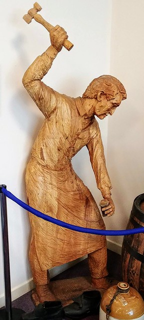 Wooden sculpture of a cooper