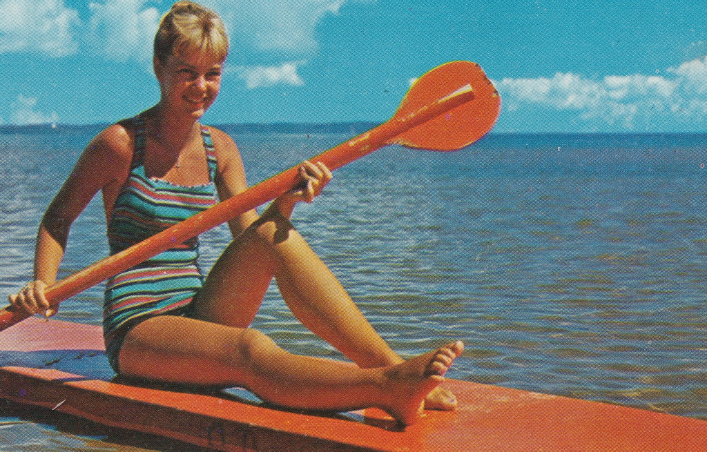 NW Traverse MI 1950s Pretty Beach Babe on an Early Paddle Board having all kinds of FUN Card say Paddleboarding is Michigans fastest growing sport Photo by PHIL BALYEAT2