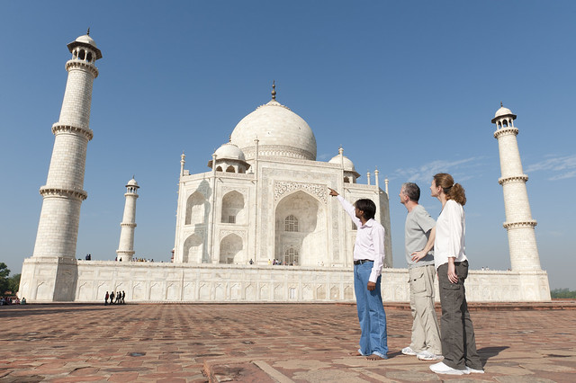 Guide points to Taj Mahal with western Tourists