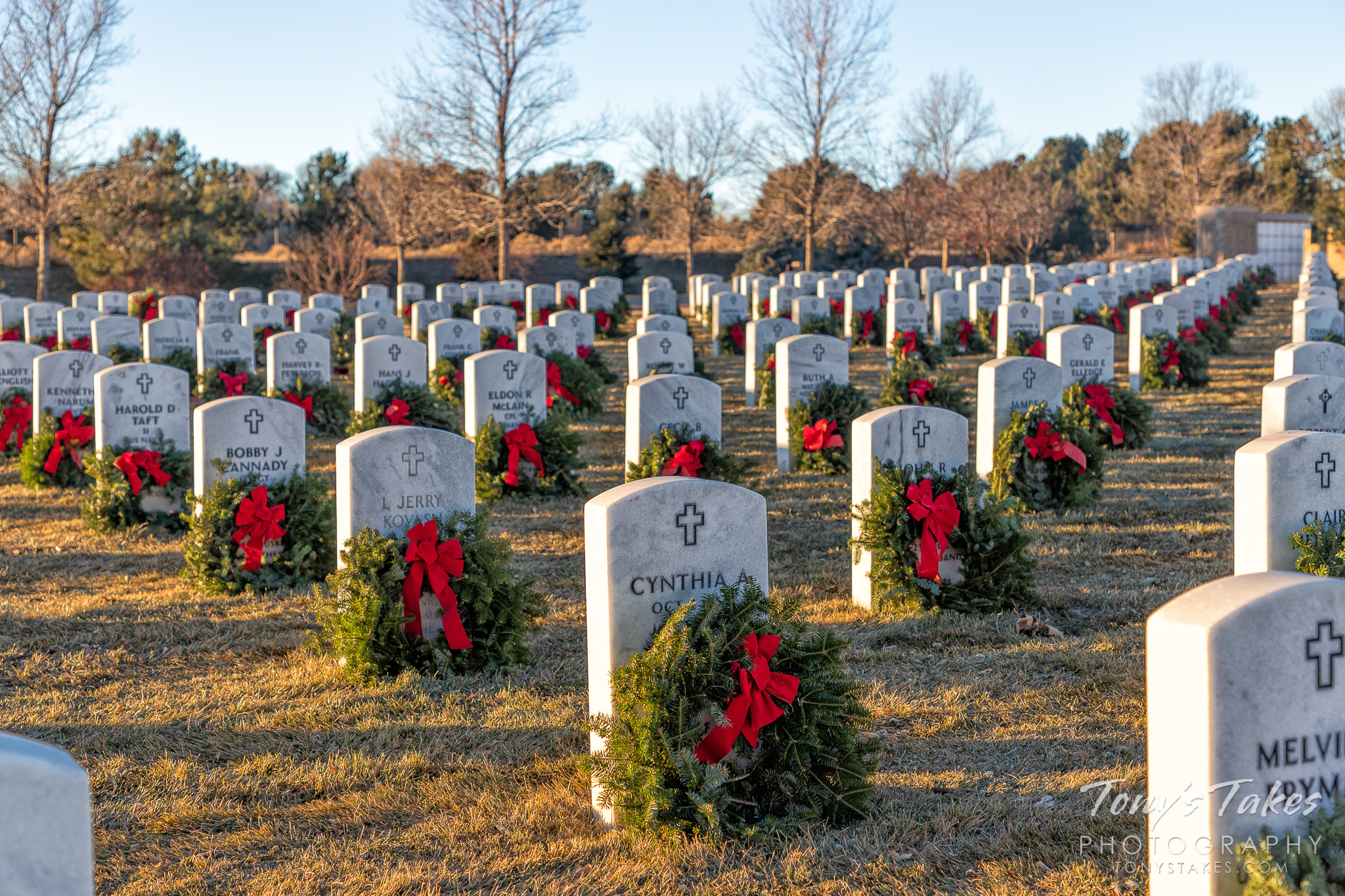 Wreaths adorn the graves of veterans at Fort Logan National Cemetery in Colorado. (© Tony’s Takes)