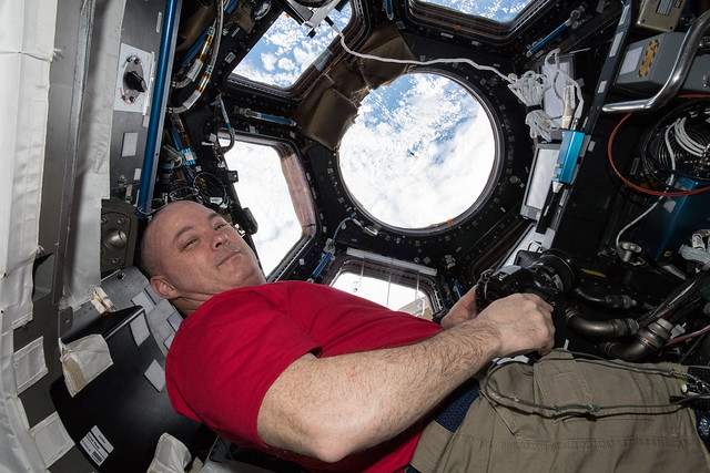 Astronaut Scott Tingle watches the SpaceX Dragon