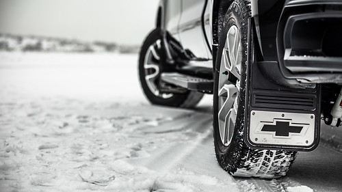 Rear view of tires of black Chevy Silverado 1500 in snow