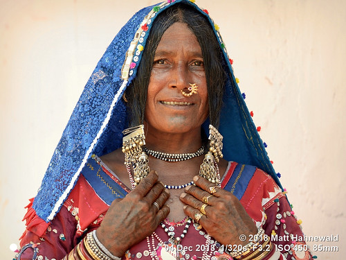 banjara lambadi gor gormati scheduledtribe matthahnewaldphotography facingtheworld character face chintattoo tattoo eyes nosejewelry jewelry silver expression hairstyle traditional clothing headscarf dupatta bodylanguage gesture bothhands respect travel exotic ethnic tribal photoshoot benaulim goa india indian gypsy lamani female elderly woman nikond610 nikkorafs85mmf18g 85mm portrait halflength closeup fullfaceview posingcamera smiling series bangles dress ring clarity colourful colour person conceptual cultural consensual lookingatcamera