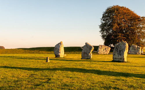 avebury stonecircle henge standingstone bank megalithic neolithic ancient grass field tree shadow sky evening landscape wiltshire