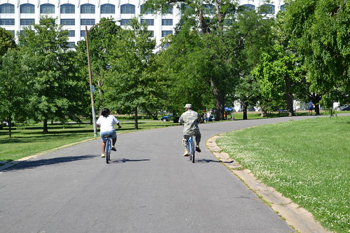 Photo of people biking on a park trail in the city