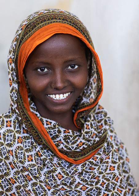 Portrait of a veiled smiling afar tribe girl with sharpened teeth, Afar Region, Afambo, Ethiopia