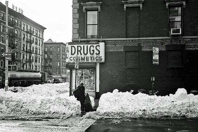 man and suitcase in the snow, new york city winter