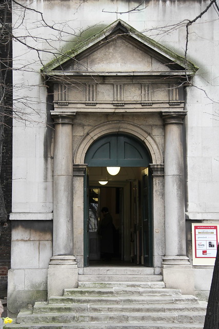 All Hallows London Wall. From the tiny garden you are greeted by welcoming steps up to a Tuscan doorway with frieze and pediment.