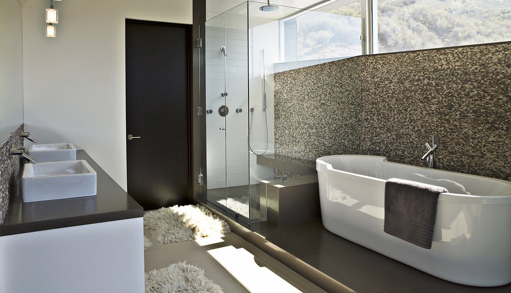Bathroom Contemporary interior design example with a big white bathtub and a black and white patterned wall. 