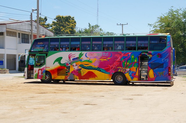 Typical Thai tourist bus parking near Mrigadayavan Palace in Cha Am, Thailand