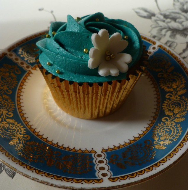 Teal and gold birthday cupcakes.