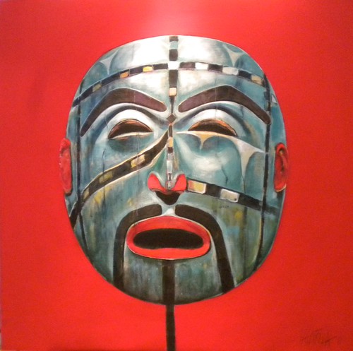 Green and grey mask with red lips on a red background