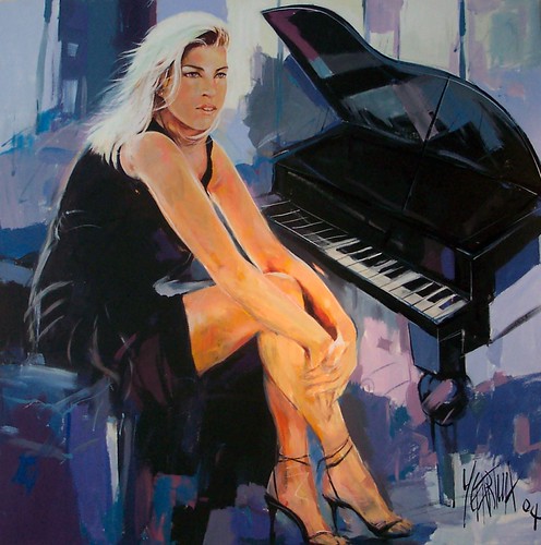 Seated woman beside a grand piano