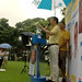 Alec Tok gives a fiery speech from the podium, while a volunteer shelters him with an umbrella. 45-year-old Alec has worked on films like 12 Storeys and A Big Road, and was a former director of the SAF Music and Drama Company. Photo: TERENCE LEE