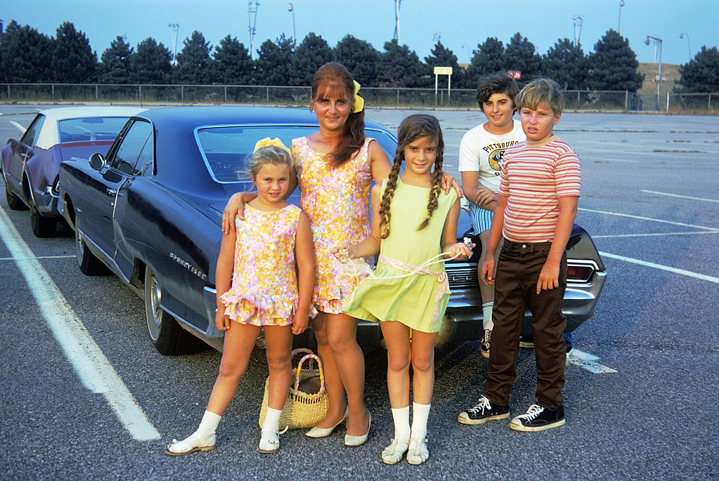 Picking up our Los Angeles cousins at JFK airport in New York so they could spend the summer with us in Milford Connecticut by the beach. I'm on the trunk and sis is in the green dress.  July 1972