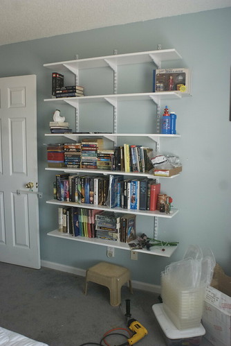 Took down three undersized shelves, replaced with six generous ones spaced to hold hardbacks. All contents of the old shelves are up; there's plenty of room left to move books from the reading room -- soon to be the sewing room.