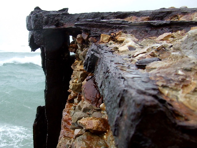 stone, wood, rusty iron and sea water