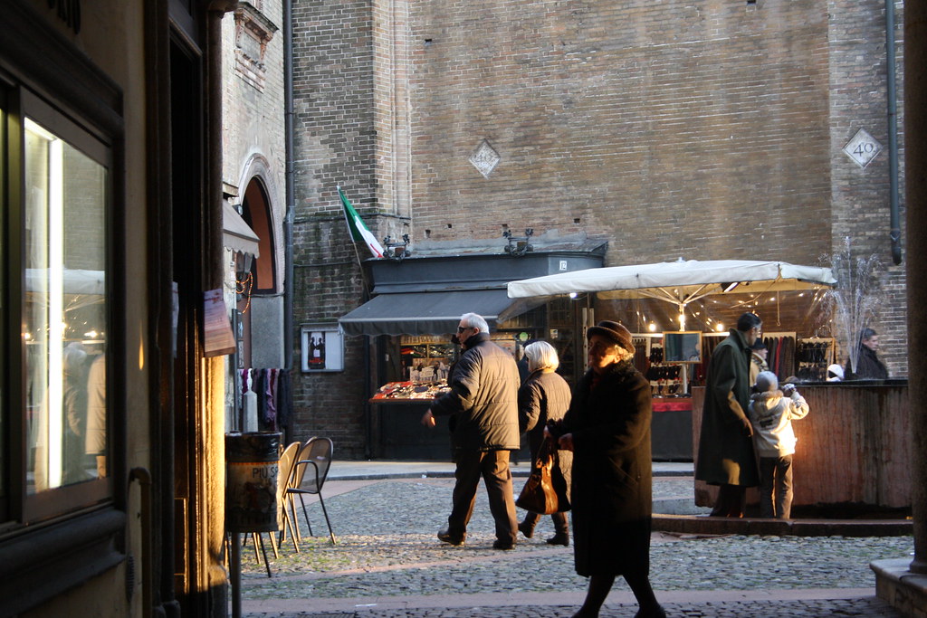 People walking through a sunlit city square