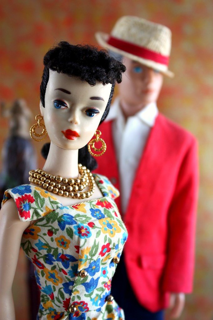 A vintage brunette #3 Barbie doll wears the colorful Pak sheath by Mattel, ...