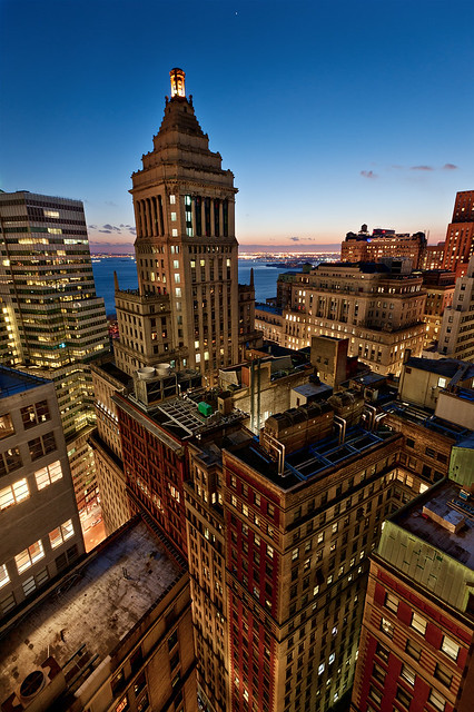 New York City Skyline and Standard Oil Building at the blue hour taken from a rooftop, Manhattan, financial district