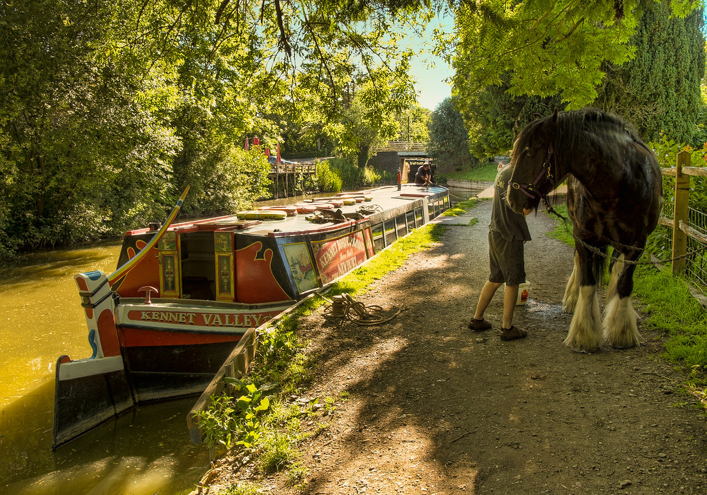 A horse drawn narrowboat on the Kennet and Avon canal at Kintbury in Wiltshire