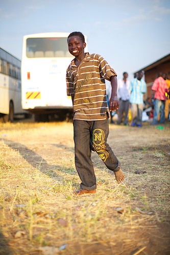 boy sunset buses smiling southsudan return unhcr waystation returnee torit easternequatoriastate