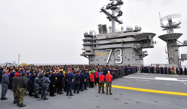 Sailors aboard USS George Washington attend an all-hands call on flight deck.