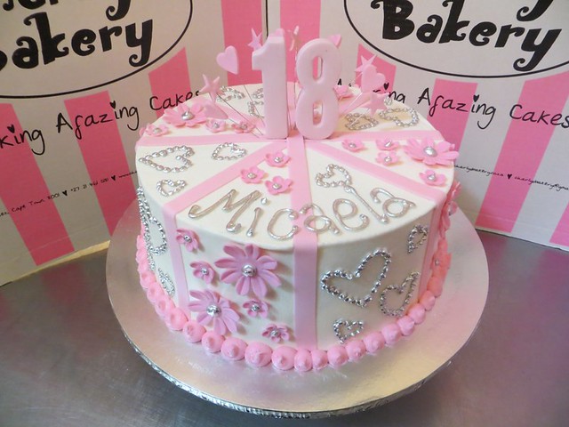 Soft pink and white 18th birthday cake with op art daisies and silver piped hearts