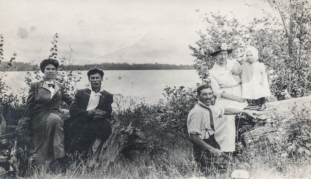 Family posing next to the water