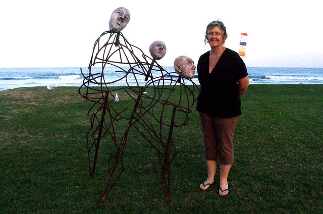 Susan McAlister with her sculpture Spirited - Sculptures on Thirroul Beach