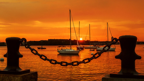 boston harbor boat water orangesky chainlink rope mooringbollard bollard longwharf massachusetts sailboat waterfront insiteimage bostonharbor sunrise