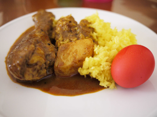 My plate: Chicken curry, yellow rice and red egg