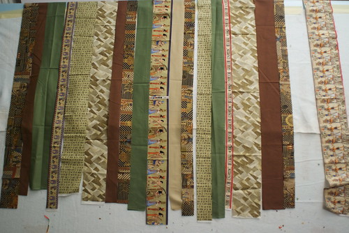 Papyrus will be a simple strip quilt. The hard part was finding the Egyptian-themed fabrics, which were out of print.

See the plan: domesticat.net/quilts/papyrus