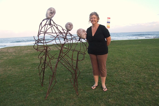 Susan McAlister with her sculpture Spirited - Sculptures on Thirroul Beach
