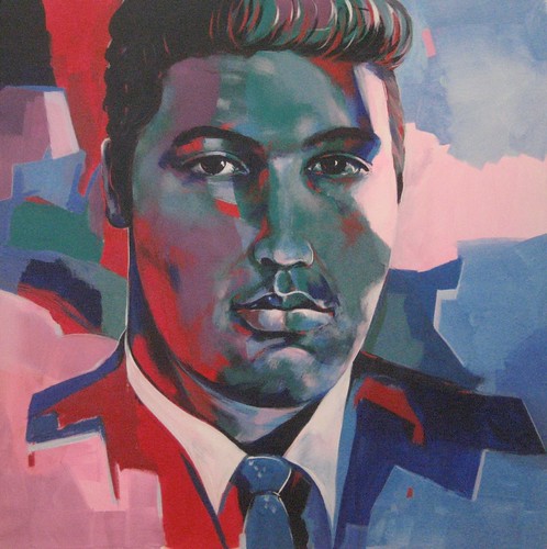 Dark-haired musician in a suit on pink and blue