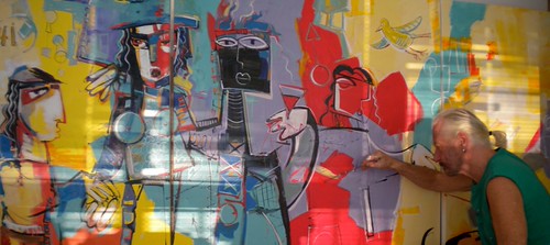 Artist painting a wide group of angular figures