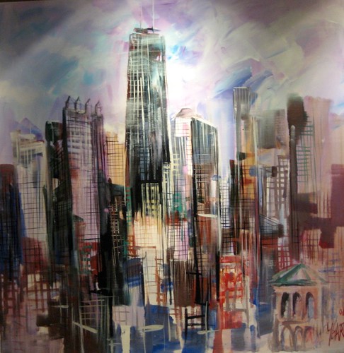 Tall pale tower among warm and cool city buildings