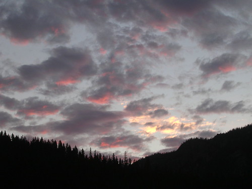Tie-dye Sky by Tim Engstrom, The clouds reflect a light pink from the sunrise beyong a ridge in the Alpine Lakes Wilderness in Wa