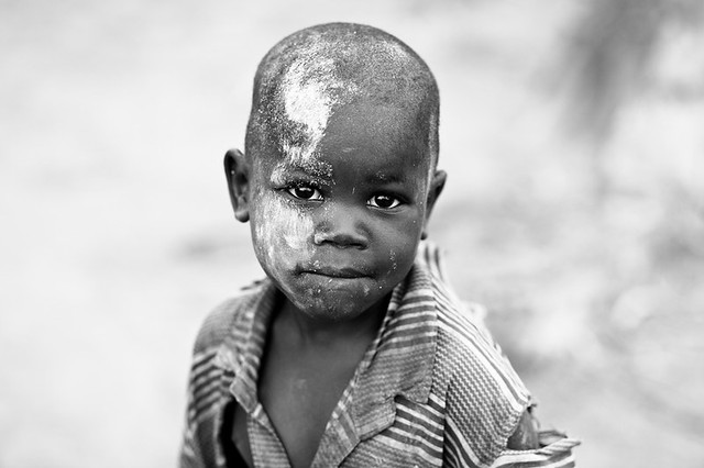 Lendu child playing with cassava flour  - DR CONGO -